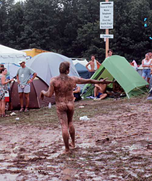 A nude Mud Man at the 1994 Woodstock II music festival preaches to the crowds of non-believers.